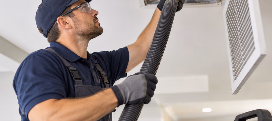 Air duct technician service a duct.