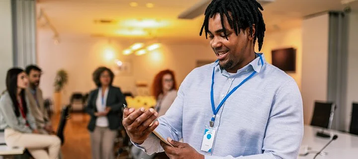 Conference attendee looking at event social media on his smartphone